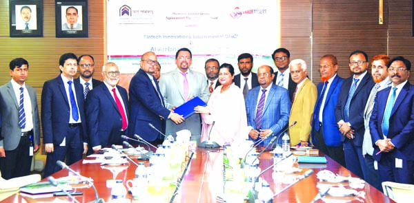 SM Jaffar, DMD of Al-Arafah Islami Bank Limited (AIBL) and Azizunnessa Huq, Executive Director of Fintech Innovations International, UAE, exchanging an agreement signing document at the Bank's head office in the city Wednesday. Under the deal, AIBL becom