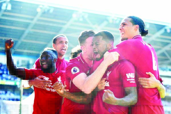 Liverpool's Georginio Wijnaldum (center) celebrates after scoring against Cardiff during their English Premier League match at Cardiff City Stadium, Cardiff, Britain on Sunday.