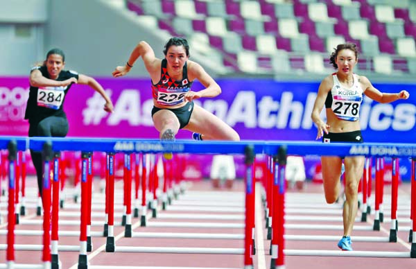 Meg Hemphill of Japan (center), Nadiah Alhaqqah of Kuwait (left) and Jeong Yeonjin of South Korea compete during Heat 1 for 100m hurdles race of the decathlon at the Asian Athletics Championships in Doha, Qatar on Monday.