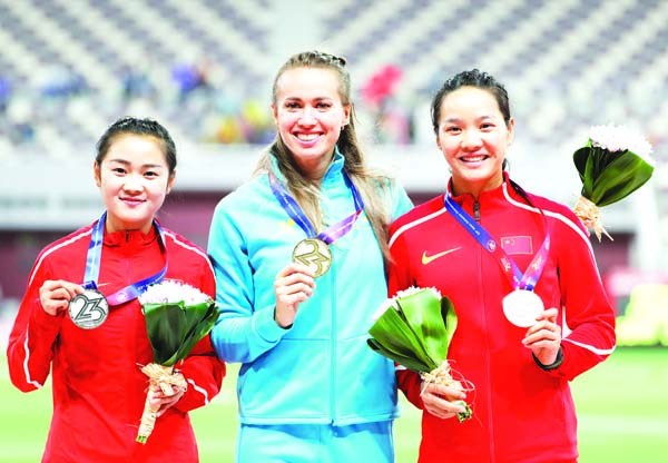 (From left) China's Liang Xiaojing, Kazakhstan's Olga Safronova and China's Wei Yongli display their silver, gold and bronze medals respectively for the women's 100-meters race at the Asian Athletics Championships in Doha, Qatar on