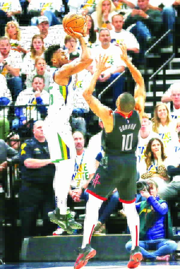 Houston Rockets guard Eric Gordon (10) defends against Utah Jazz guard Donovan Mitchell (center left) in the first half during Game 4 of a first-round NBA basketball playoff series in Salt Lake City on Monday.