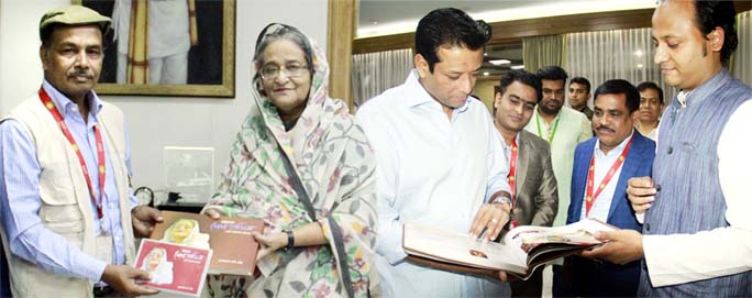 A photo album titled 'Sheikh Hasina in Chattogram ' handing over to Prime Minister Sheikh Hasina and her son Sajeeb Wazed Joy at a simple ceremony at Prime Minister Office by senior photo journalist and freedom fighter Debu Prasad Das recently.