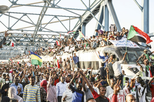 Sudanese protesters crowd a train in the capital Khartoum. Sudanese activists were holding nationwide protests on Tuesday to press the military to hand over power to a civilian authority after the overthrow of President Omar al-Bashir earlier this month.