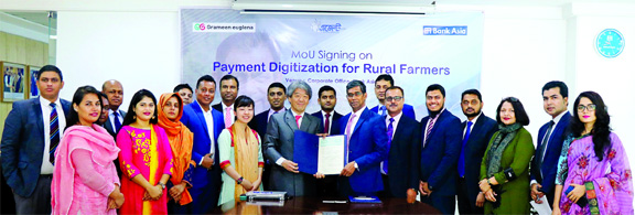 Md. Arfan Ali, Managing Director of Bank Asia Limited and Yukoh Satake, Co-CEO of Grameen Euglena (A joint venture social business company of Japan & Bangladesh), exchanging a MoU signing document on digitizing payment services for farmers at the Bank's