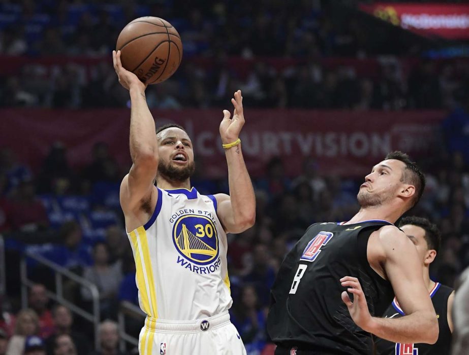 Golden State Warriors guard Stephen Curry (left) shoots as Los Angeles Clippers forward Danilo Gallinari defends during the first half in Game 6 of a first-round NBA basketball playoff series in Los Angeles on Friday.
