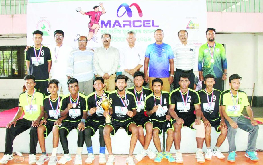Members of Chapainawabganj DSA team, who finished third in the 4th Marcel National Youth (Men's) Handball Competition with the guests and officials of Bangladesh Handball Federation pose for a photo session at the Shaheed (Captain) M Mansur Ali Nat