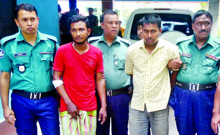 Arrested motor cycle rider Sumon (left) of Brac University Student Labonya and covered van driver Anisur Rahman being brought to Deputy Police Commissioner Office in city on Sunday.