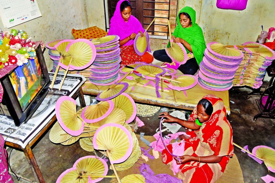 Hand fans being made with palm leaves at city's Bhatara area in Gulshan area on Tuesday.