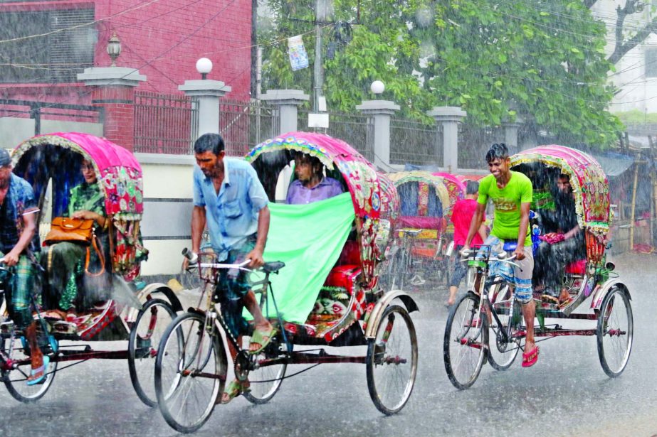 Rickshaw-pullers smile as they heave a sigh of relieve after raining though cyclone 'Fani' sweeping across the southern region of the country. This photo was taken from cityâ€™s Tejgaon area on Friday.