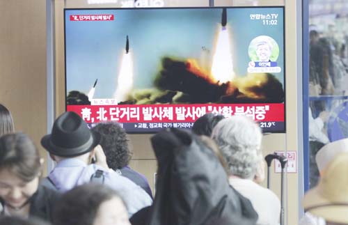 People watch a TV showing a file footage of North Korea's missile launch during a news programme at the Seoul Railway Station in Seoul, South Korea on Saturday.