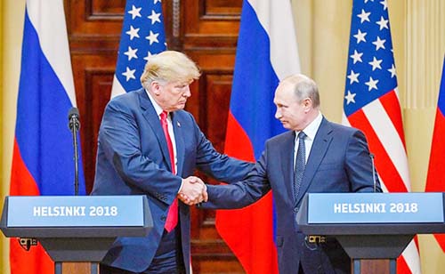 U.S. President Donald Trump and Russian President Vladimir Putin shake hands as they hold a joint news conference after their meeting in Helsinki, Finland. AP file photo