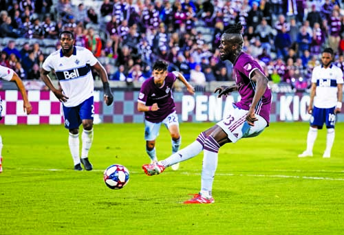 Colorado Rapids forward Kei Kamara takes a penalty kick and scores a goal against the Vancouver Whitecaps during the first half of an MLS soccer match in Commerce City, Colo on Friday.