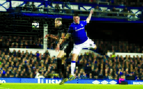 Burnley's Ashley Barnes (left) and Everton's Michael Keane battle for the ball during the English Premier League soccer match between Everton and Burnley at Goodison Park, Liverpool, England on Friday.