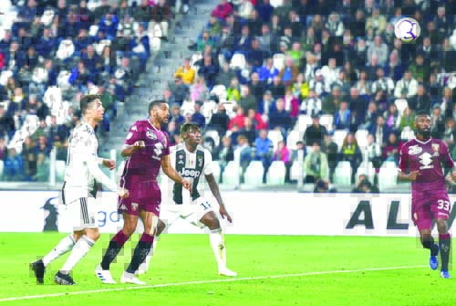 Juventus's Cristiano Ronaldo (left) scores a goal during the Italian Serie A soccer match between Juventus FC and Torino FC at the Allianz Stadium in Turin, Italy on Friday.