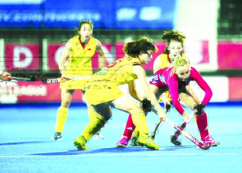 Britain's Hannah Martin and China's Jinrong Zhang battle for the ball during the FIH Pro League match at the Lee Valley Hockey and Tennis Centre, London on Friday.