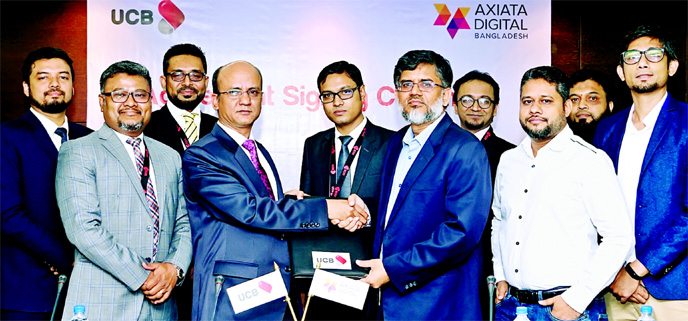 Md Abdullah Al Mamoon, DMD of United Commercial Bank (UCB) Limited and Shihab Ahmad, Managing Director of Axiata Digital Bangladesh (Pvt) Limited, exchanging an agreement signing document on buying tickets from BDTICKETS using UPAY Wallet at the Bank's h