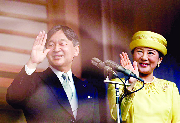 Japan's Emperor Naruhito and Empress Masako greet well-wishers during their first public appearance at the Imperial Palace in Tokyo on Saturday.