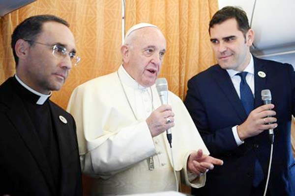 Pope Francis greets reporters during his flight from Rome, Italy to Sofia, Bulgaria on Sunday.