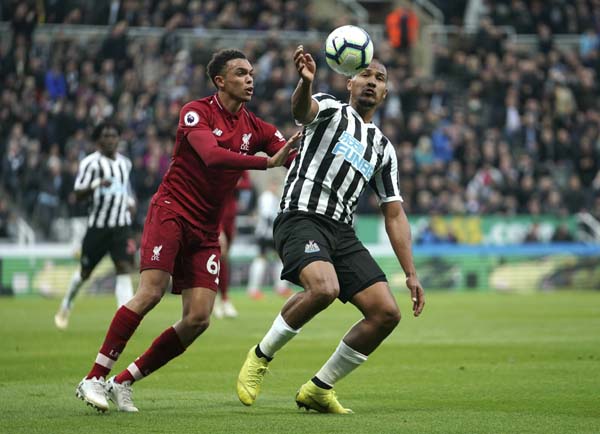 Liverpool's Trent Alexander-Arnold (left) and Newcastle United's Salomon Rondon battle for the ball during the English Premier League soccer match at St James' Park, Newcastle, England on Saturday.