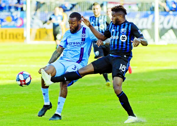 Montreal Impact's Orji Okwonkwo (right) challenges New York City FC's Sebastien Ibeagha during first half of an MLS soccer game in Montreal on Saturday.
