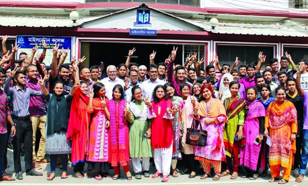 Teachers, students and guardians of the city's Milestone College showing victory (V) sign over the brilliant results of the SSC examination on the campus of the college on Monday.