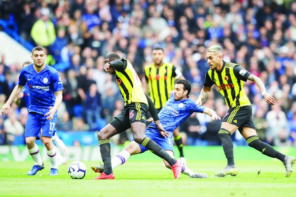 Chelsea's Pedro (center) fights for the ball with Watford's Abdoulaye Doucoure (left) during the English Premier League soccer match between Chelsea and Watford at Stamford Bridge stadium in London on Sunday.