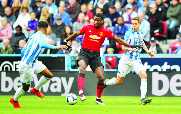 Manchester United's Paul Pogba in action during the English Premier League soccer match against Huddersfield Town at the John Smith's Stadium, Huddersfield, England onÂ Sunday.