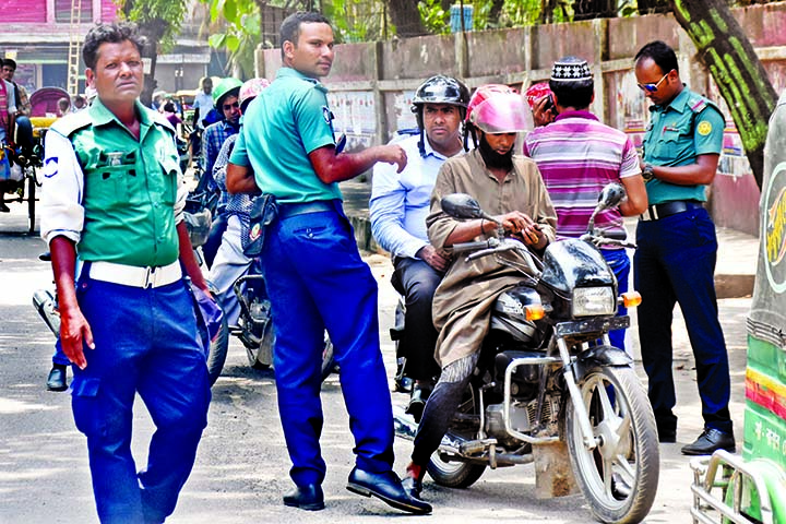 Law enforcers seen to check documents of various vehicles including motorcycles setting up check-post in different areas in the city. The snap was taken from Bangabazar intersection on Tuesday.