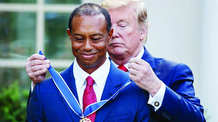 President Donald Trump presents the Presidential Medal of Freedom to Tiger Woods during a ceremony in the Rose Garden of the White House in Washington on Monday.