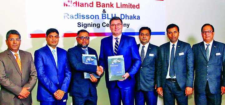 Md. Ridwanul Hoque, EVP and Head of Retail Distributions of Midland Bank Ltd and Alexander Haeusler, General Manager of Radisson Blu, Dhaka Water Garden, sign an agreement at the hotel premises in the city on Sunday. Under this agreement, the Bank's Visa