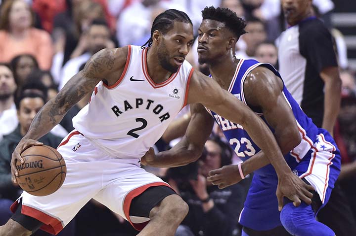 Toronto Raptors forward Kawhi Leonard (2) controls the ball as Philadelphia 76ers guard Jimmy Butler (23) defends during the first half of Game 5 of an NBA basketball second-round playoff series in Toronto on Tuesday.