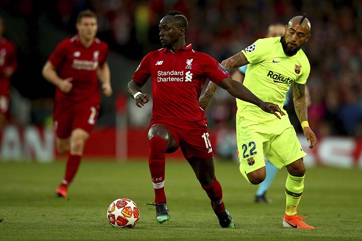 Liverpool's Sadio Mane fights for the ball against Barcelona's Arturo Vidal during the Champions League semifinal, second leg, soccer match between Liverpool and FC Barcelona at the Anfield stadium in Liverpool, England on Tuesday.