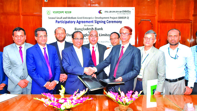 AKM Fazlur Rahmna, Project Director of SMEDP-2 and Executive Director of Bangladesh Bank (BB) and Abul Kashem Md. Shirin, Managing Director of Dutch-Bangla Bank Limited (DBBL), exchanging an agreement signing document at BB head office in the city on Tues