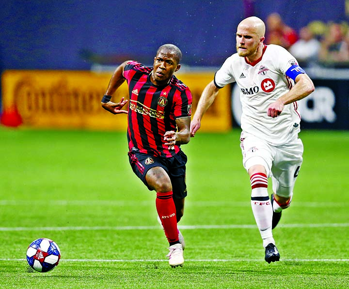Atlanta United midfielder Darlington Nagbe (left) and Toronto FC midfielder Michael Bradley chase the ball during the first half of an MLS soccer match in Atlanta on Wednesday.