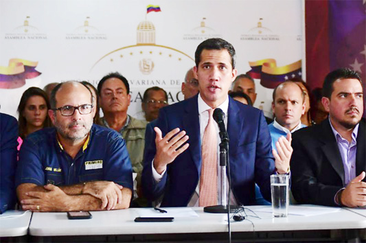 Venezuelan opposition leader Juan Guaido (center) accuses Nicolas Maduro's regime of 'state terrorism'