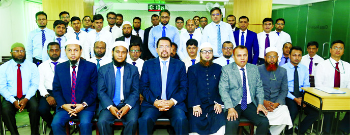 Farman R Chowdhury, Managing Director and CEO of Al-Arafah Islami Bank Ltd, poses with the participants of a day-long training workshop on 'Shariah Implementation in AIBL' at its Training and Research Institute recently. Principal of the Institute and E