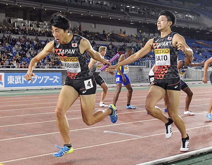 Japan's Kota Wakabayashi (left) races after receiving the button from Kentaro Sato (right) in the heat of the Men's 4x400m Relay at the IAAF World Relays in Yokohama, Japan on Saturday.