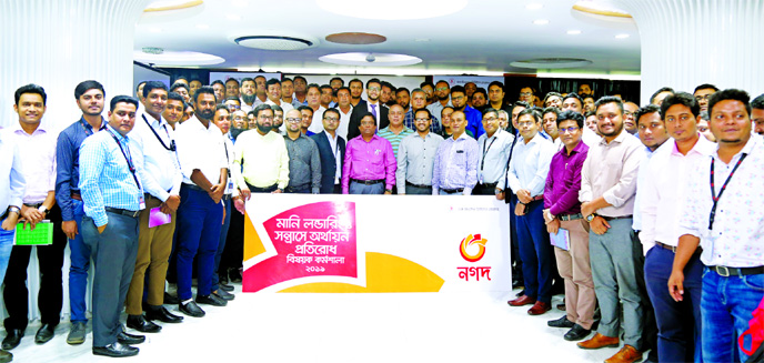 Shudhangshu Shekhar Bhadra, Director General of Bangladesh Post Office and Tanvir Ahmed Mishuk, Managing Director of Nagad, pose with the participants of a training session on "Anti-Money Laundering and Combating Financing of Terrorism" for all of its e
