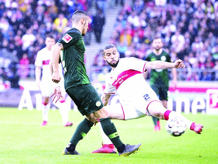 Stuttgart's Emiliano Insua (right) and Wolfsburg's William challenge for the ball during the German Bundesliga soccer match between VfB Stuttgart and VfL Wolfsburg in Stuttgart, Germany on Saturday.