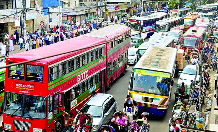 Dhaka city plunges into massive traffic chaos as thousands of vehicles got stuck for hours during Ramzan, causing immense sufferings to commuters. This photo was taken from Bijoynagar and Motijheel area (inset) on Sunday.