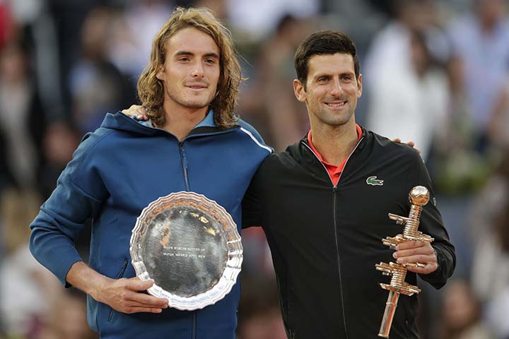 Serbia's Novak Djokovic (right) holds the trophy as he celebrates winning the final of the Madrid Open tennis tournament in two sets, 6-3, 6-4, against Greece's Stefanos Tsitsipas (left) in Madrid, Spain on Sunday.