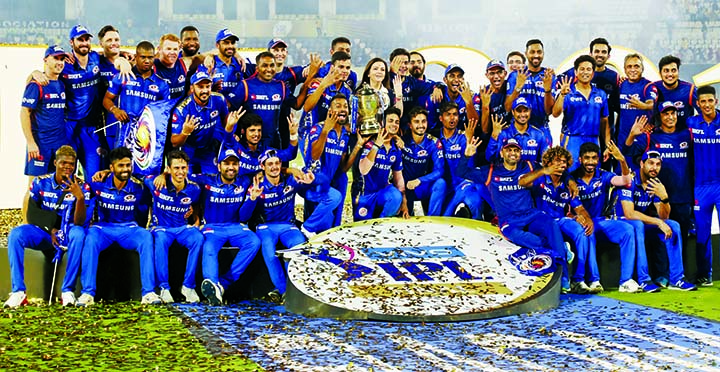 Members of Mumbai Indians team and team owner Nita Ambani (center) pose with the trophy after their win over Chennai Super Kings in the final cricket match of VIVO IPL T20 in Hyderabad, India on Sunday.