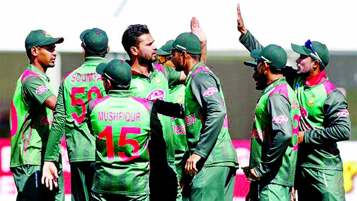 Mashrafe Bin Mortaza (center) of Bangladesh, celebrates with his teammates after dismissal of Jason Holder (not in the picture) during their One Day International (ODI) match of the Tri-Nation Series between Bangladesh and West Indies at Dublin in Ireland