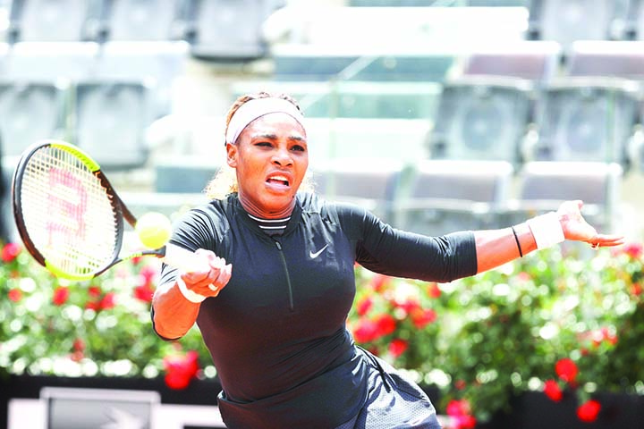 Serena Williams, of the United States, returns the ball to Sweden's Rebecca Peterson during their match at the Italian Open tennis tournament, in Rome on Monday.