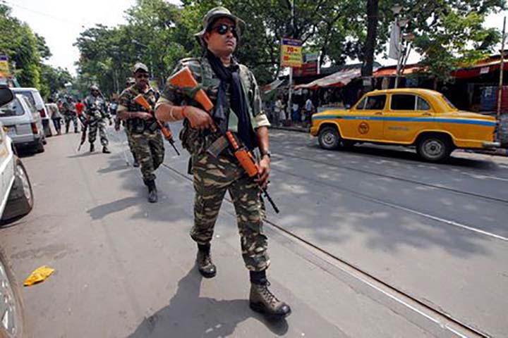 Central Reserve Police Force (CRPF) personnel conduct route march in a street ahead of the seventh and last phase of general election, in Kolkata on Wednesday.