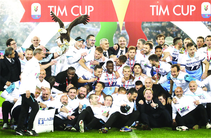 Lazio team poses after winning the Italian Cup trophy at the end of the final match between Lazio and Atalanta, at the Rome Olympic stadium on Wednesday.