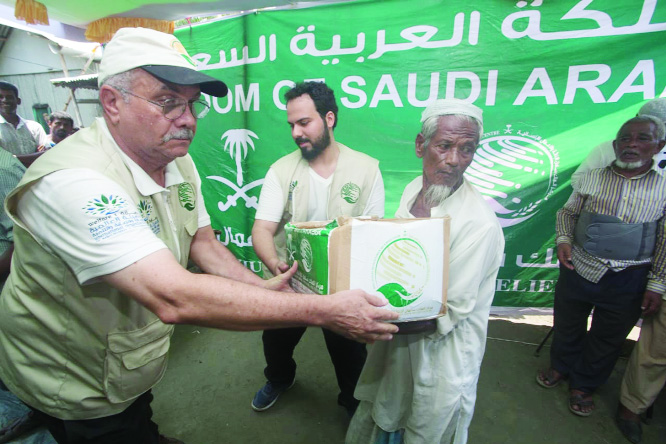 COX'S BAZAR: King Salman Humanatrian Aid and Relief Centre officials distributing food baskets among Rohingya people through International Organization for Relief, Welfare and Development (IORWD) at Kutupalong camp in Cox's Bazar yesterday .