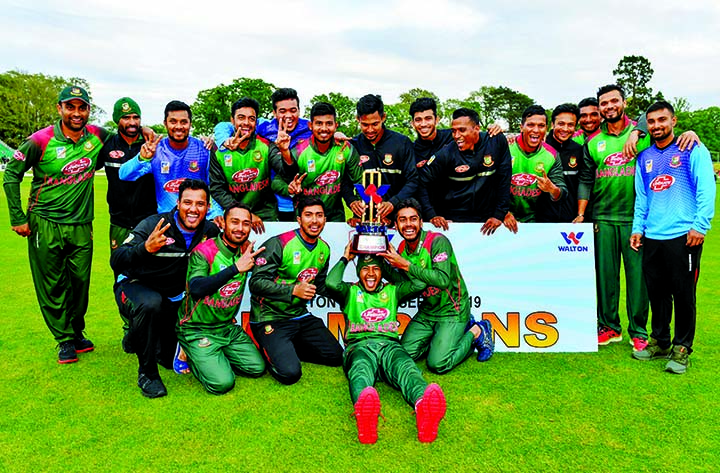 Members of Bangladesh National Cricket team, the champions in the Tri-Nation ODI Series pose with the championship trophy after beating West Indies in the final at Dublin in Ireland on Friday.
