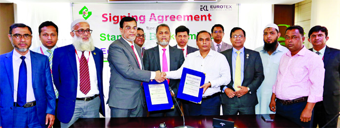 Deputy Managing Director of Standard Bank Ltd. Md. Motaleb Hossain and Managing Director of Eurotex Knitwear Limited Md. Shahidul Islam, sign an agreement signing document for specialized service "Employee Savings Account Services" at the Bank's head o
