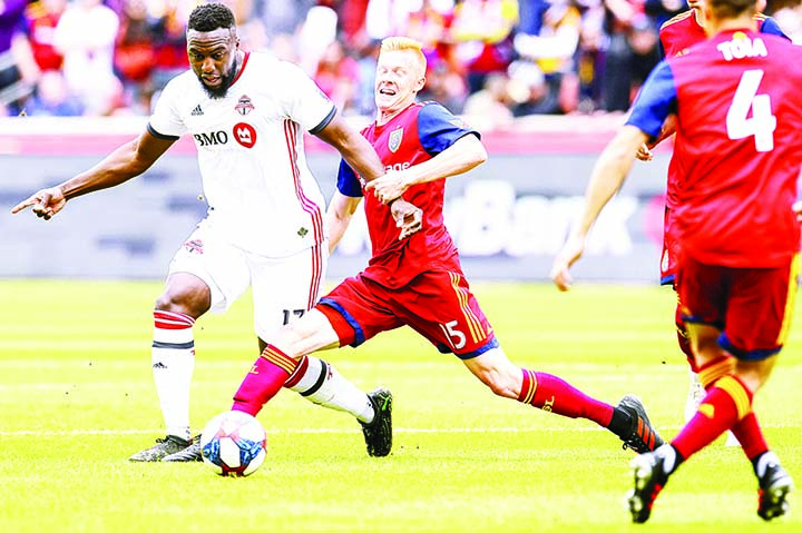 Real Salt Lake defender Justen Glad (15) grabs the wrist of Toronto FC forward Jozy Altidore (17) during an MLS soccer match in Sandy Utah on Saturday.